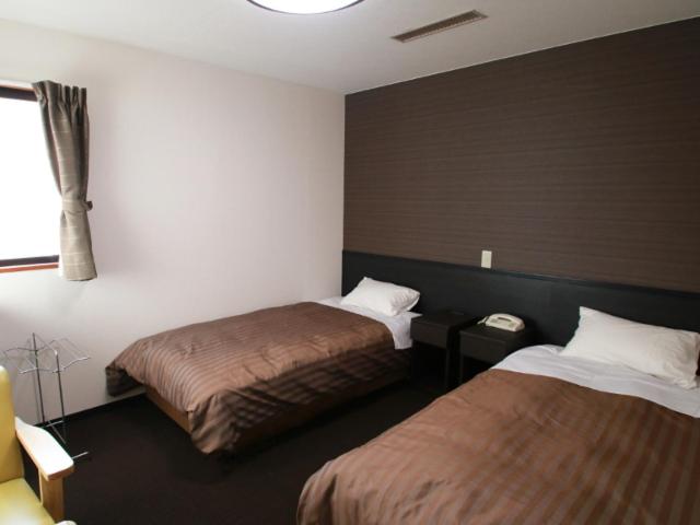 Postel nebo postele na pokoji v ubytování Hotel Oonoya