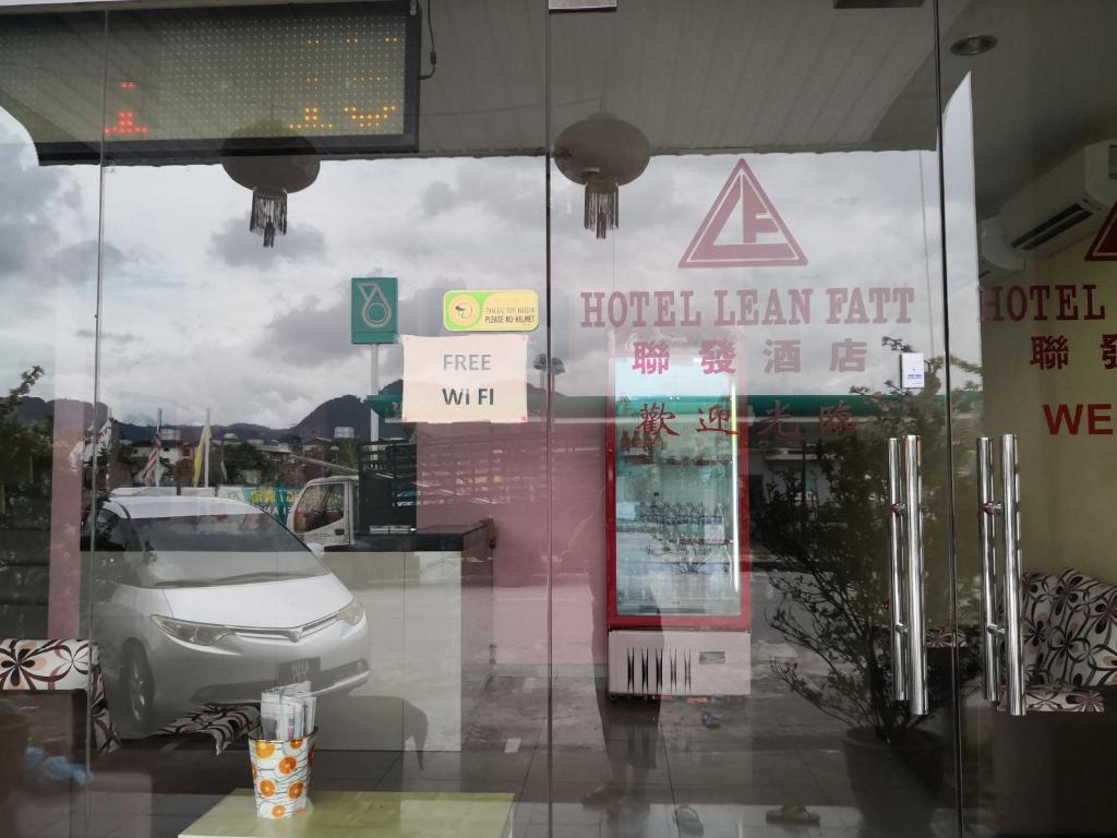 a hotellean leaf half sign on the window of a car dealership at Hotel Lean Fatt in Ipoh