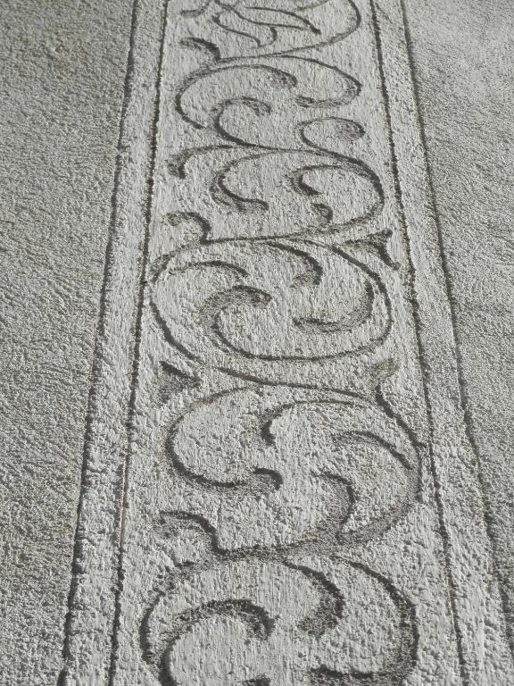 a row of drawings on the floor of a sidewalk at Palazzo Mysanus Samedan in Samedan