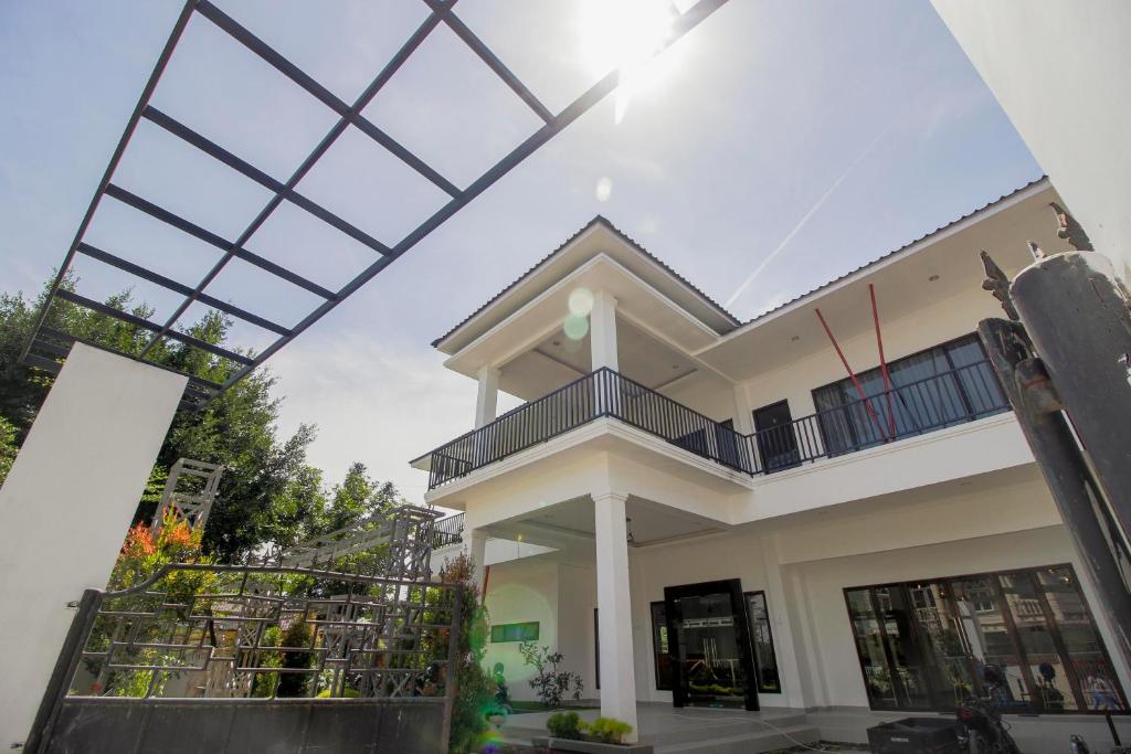 a house with a large glass roof at RedDoorz Premium @ Setiabudi Medan in Sunggal