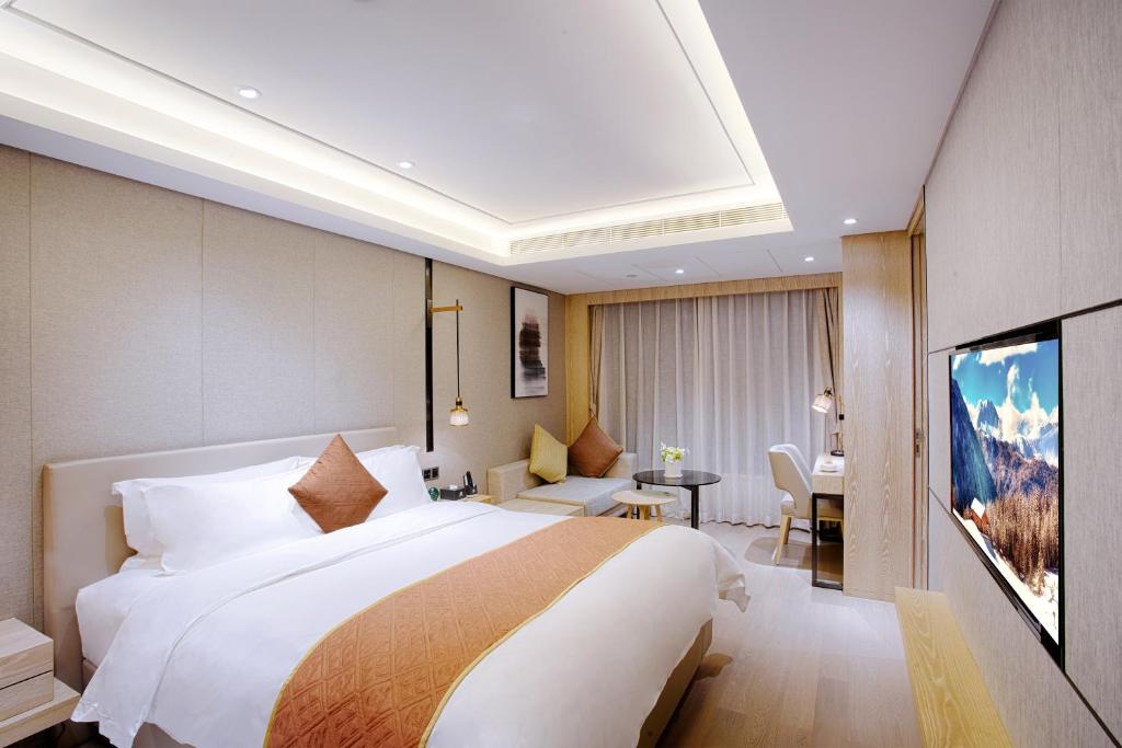 Postel nebo postele na pokoji v ubytování Shenzhen FY Hotel