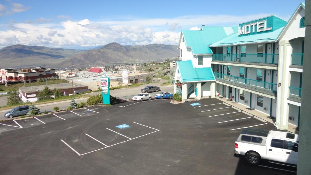 a view of a hotel with a parking lot at Alpine Motel in Kamloops