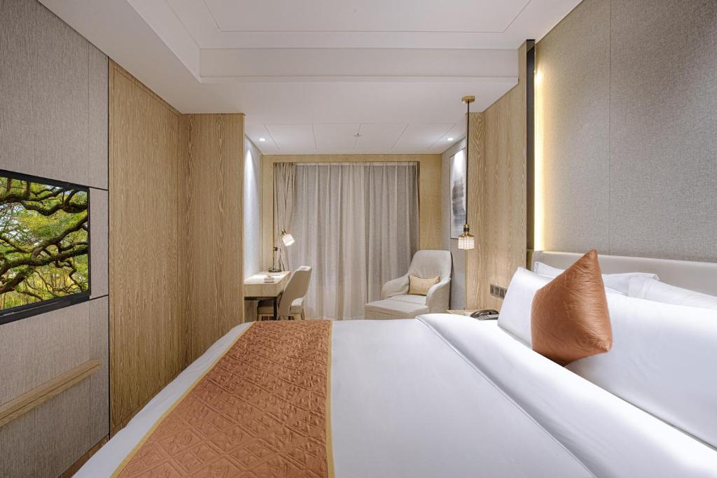 Postel nebo postele na pokoji v ubytování Shenzhen FY Hotel