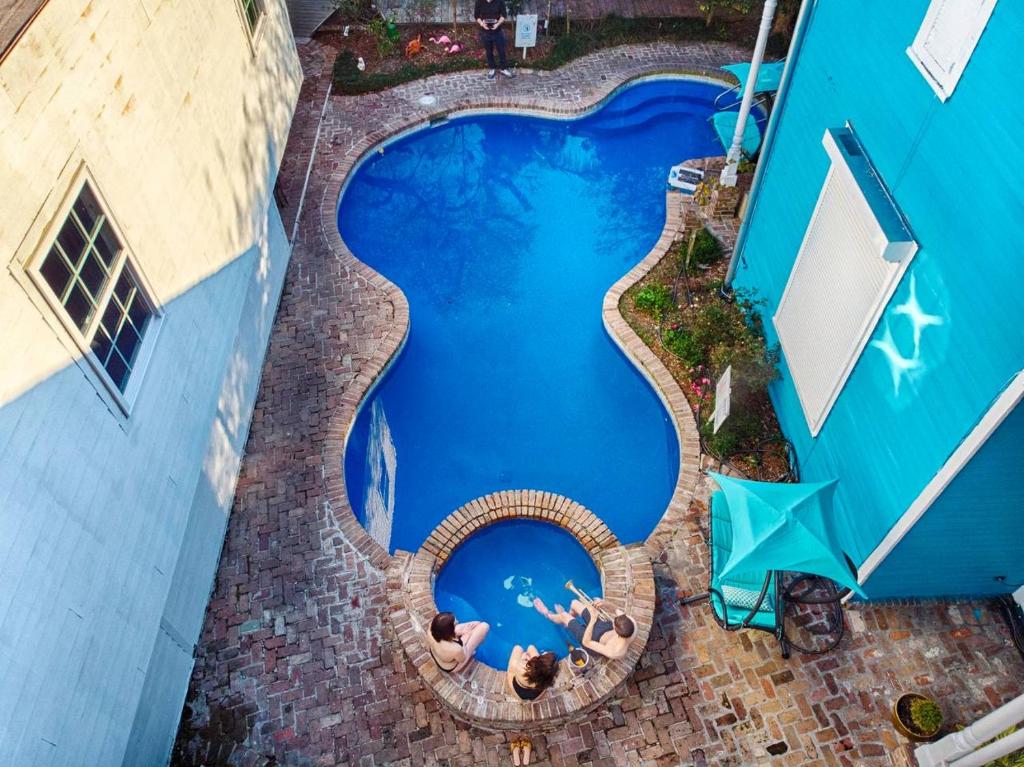 an overhead view of a swimming pool next to a building at 4 BR - Sleeps 8! Celebrity Villa Next to Frenchman St in New Orleans