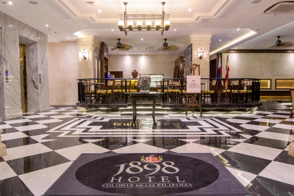 a lobby of a hotel with a table and chairs at 1898 Hotel Colonia En Las Filipinas in Manila