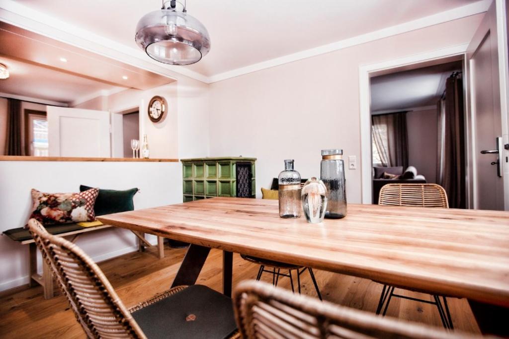 a dining room with a wooden table and chairs at Ferienhaus Hotel Hirschen Horn in Gaienhofen
