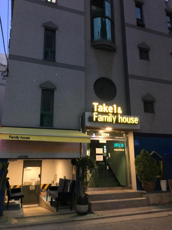 a building with a sign for a family house at Take 1 Guesthouse Hongdae in Seoul