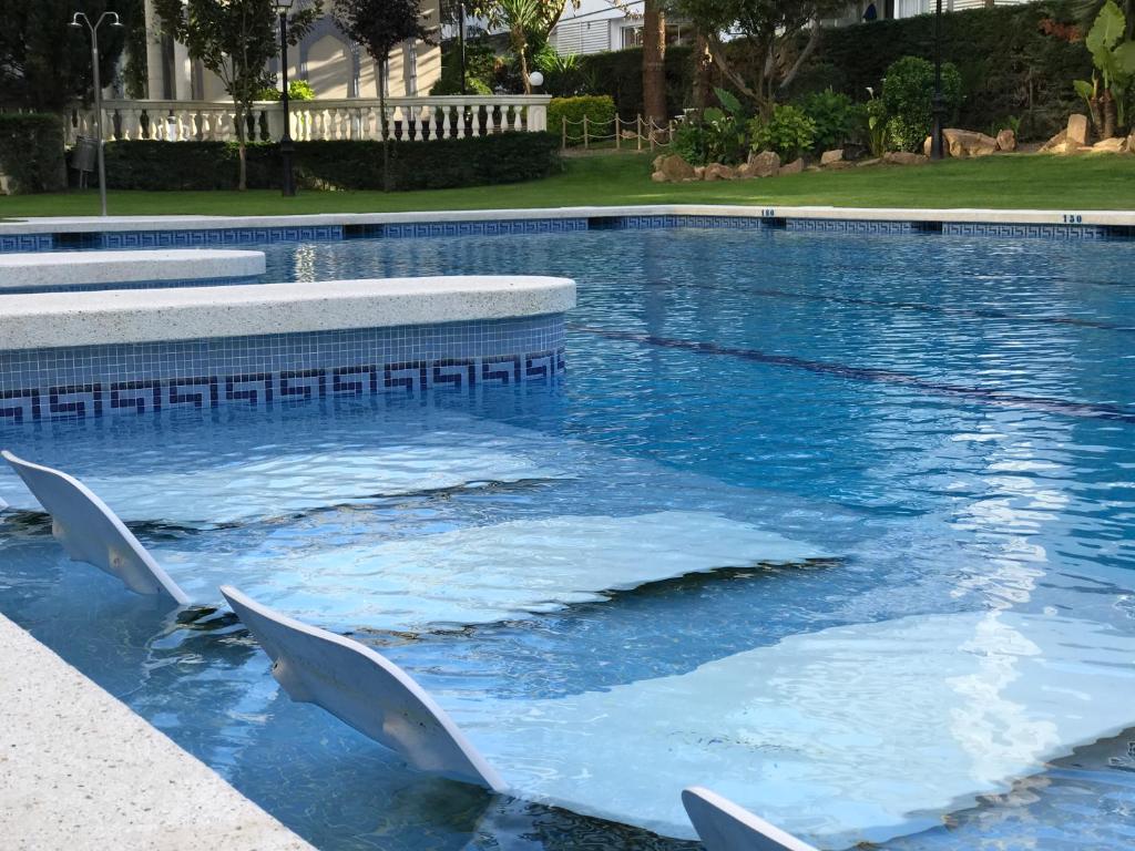 a swimming pool with ice in the water at MY ALVA PARK - 50m from the beach in Lloret de Mar