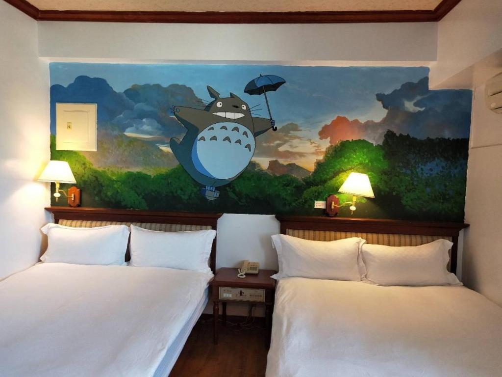 A bed or beds in a room at Little Paradise Inn