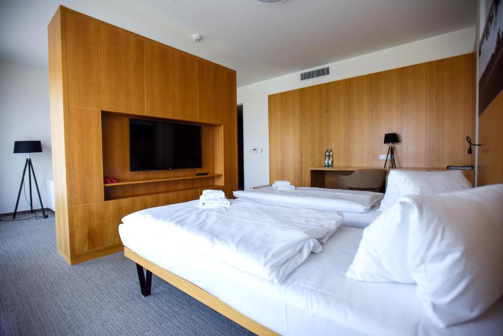 Postel nebo postele na pokoji v ubytování Hotel S-PORT Véska