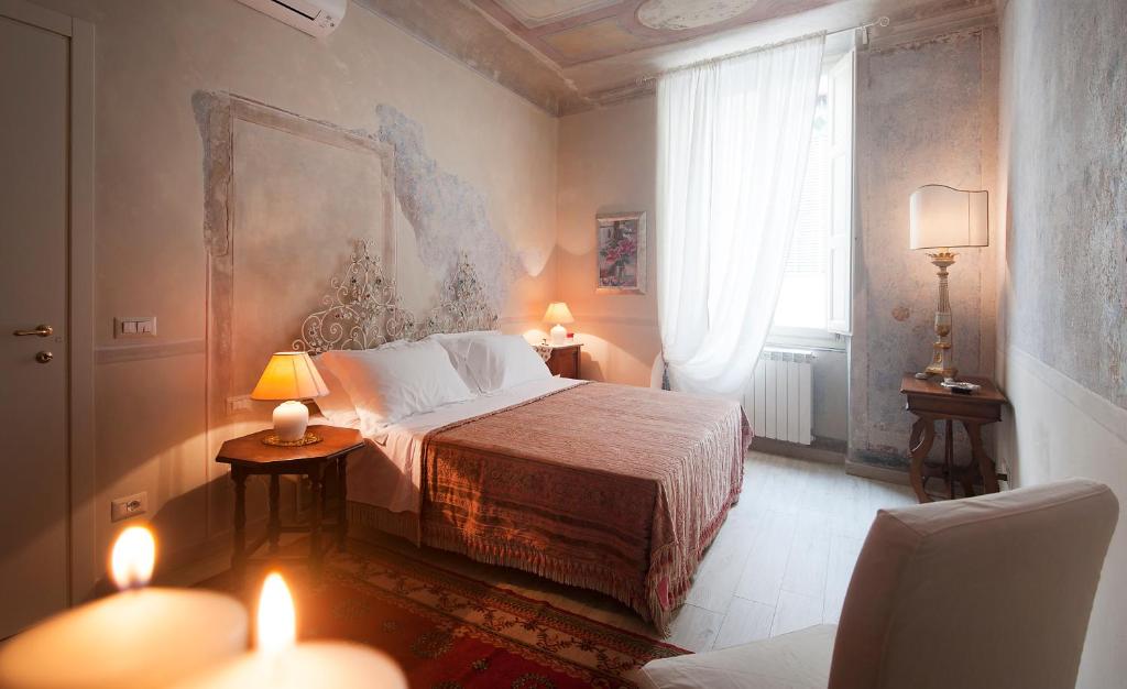 a bedroom with a bed and a lamp at San Lorenzo Apartments in Florence