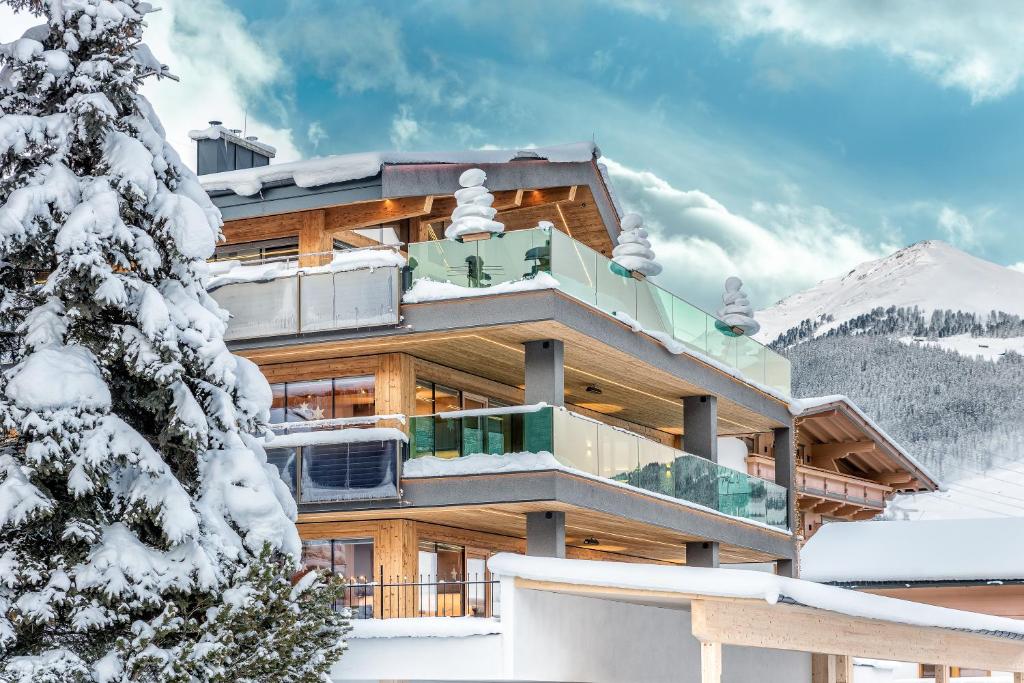 una cabaña en la nieve con un árbol en Sruh Prime Apart, en Gerlos