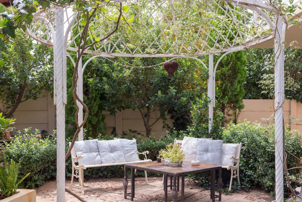 a gazebo with two chairs and a table at Bri-Shel Manor B&B in Heidelberg