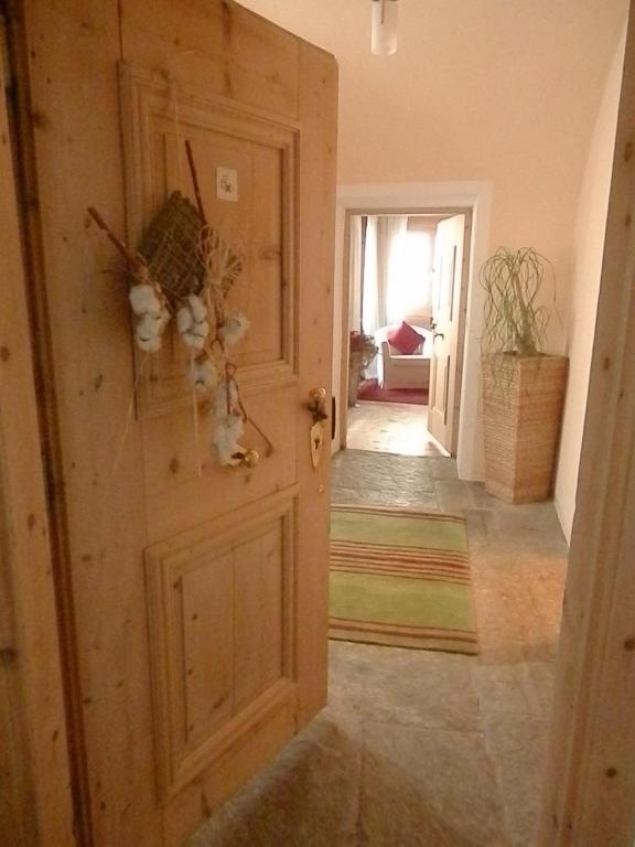 a room with a door and a hallway with a room at Palazzo Mysanus Samedan in Samedan