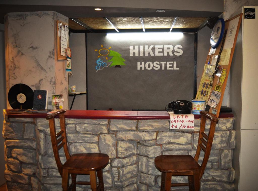 a bar with two chairs and a sign that reads hieves hospital at Hikers Hostel in Plovdiv