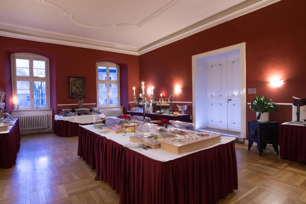 a large room with a table with food on it at Klosterhotel Wöltingerode in Goslar