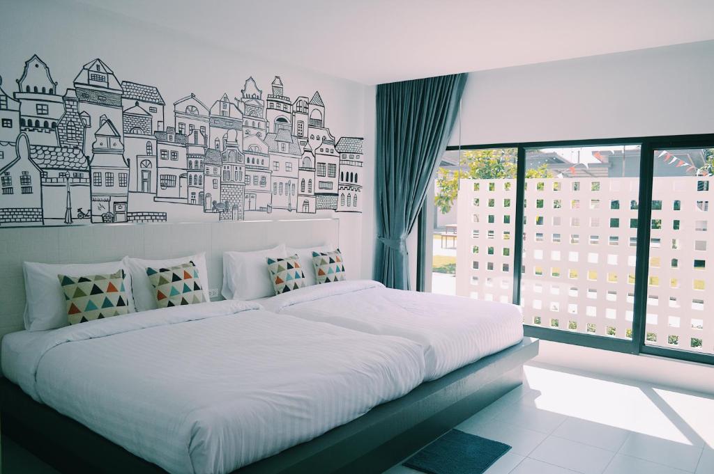 En eller flere senge i et værelse på Wannachart Boutique Resort