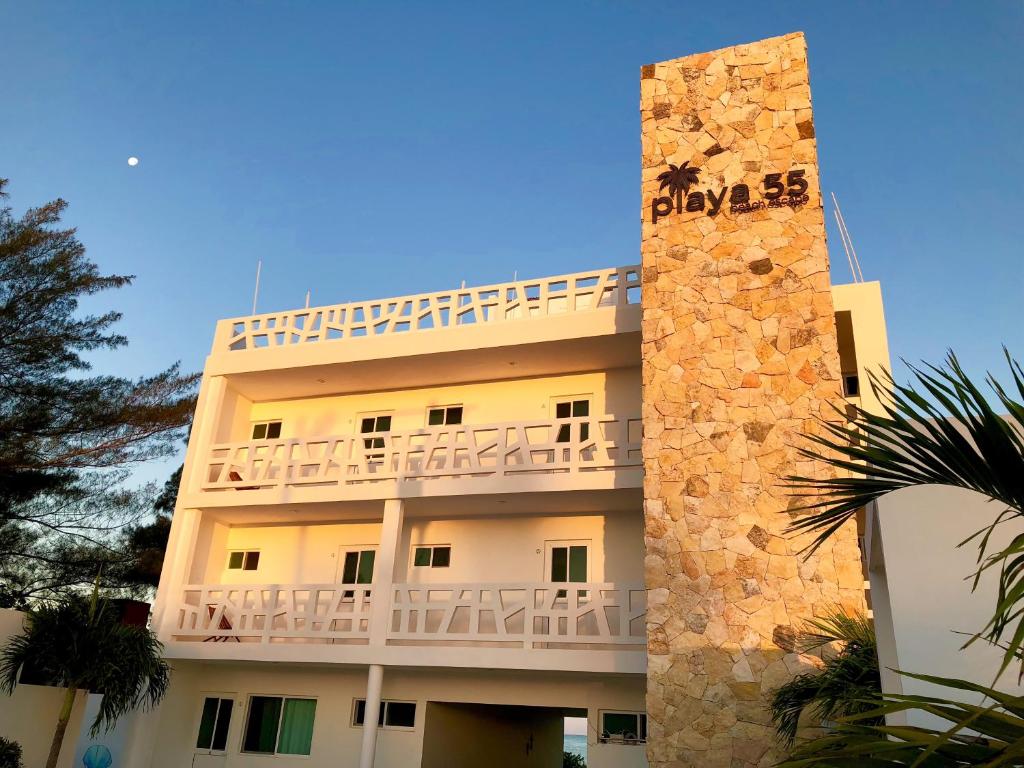 a building with a balcony on the side of it at Playa 55 beach escape - adults only Guesthouse in Celestún