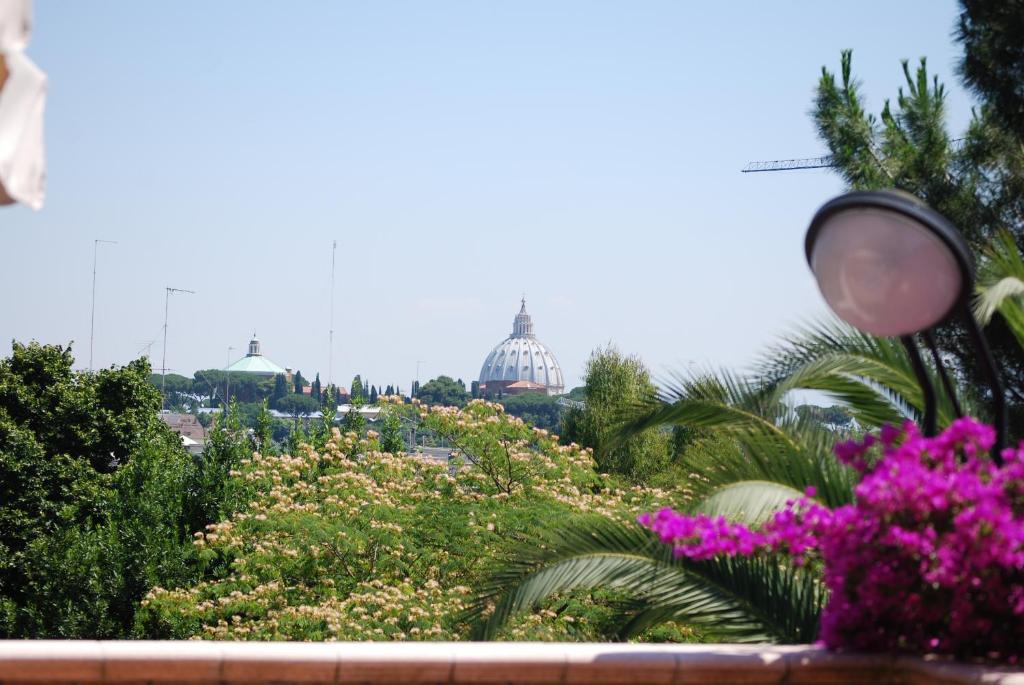 a view of the capitol from a garden with flowers at Villa Aurelia in Rome