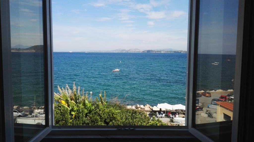 a view of the ocean from a window at Terrazzo 73 in Ischia