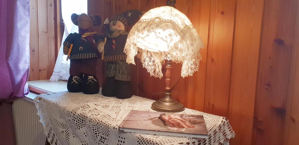 a lamp on top of a table with a book at Civico 10 in Candide