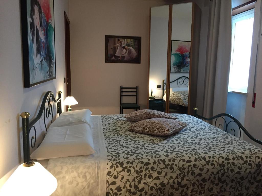 a bedroom with a bed with two pillows on it at M'ami in Magliano deʼ Marsi
