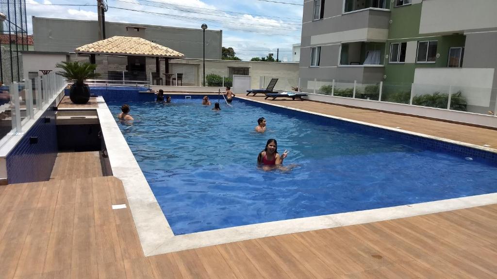 a group of people swimming in a swimming pool at Easy Club 308 in Piçarras