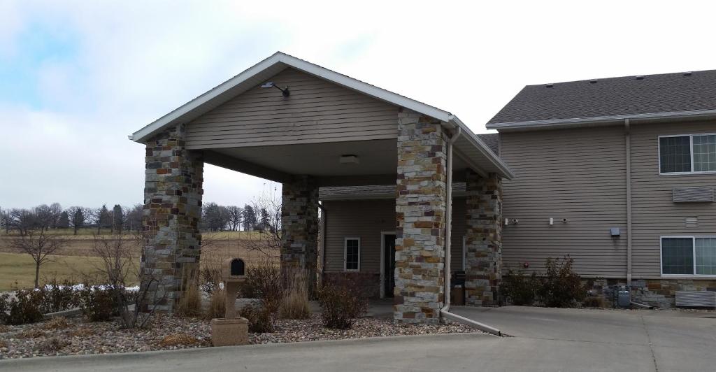 a house with a large garage in front of it at Rock Island Inn & Suites in Atlantic