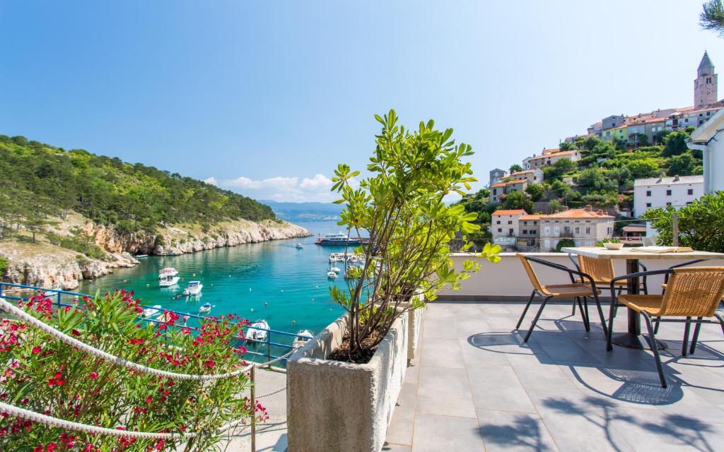 a balcony with a view of a body of water at Seafront Apartment With Amazing Seaview in Vrbnik