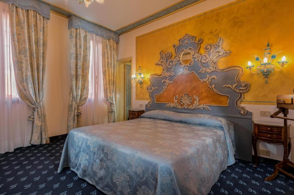 Postel nebo postele na pokoji v ubytování Hotel Giorgione