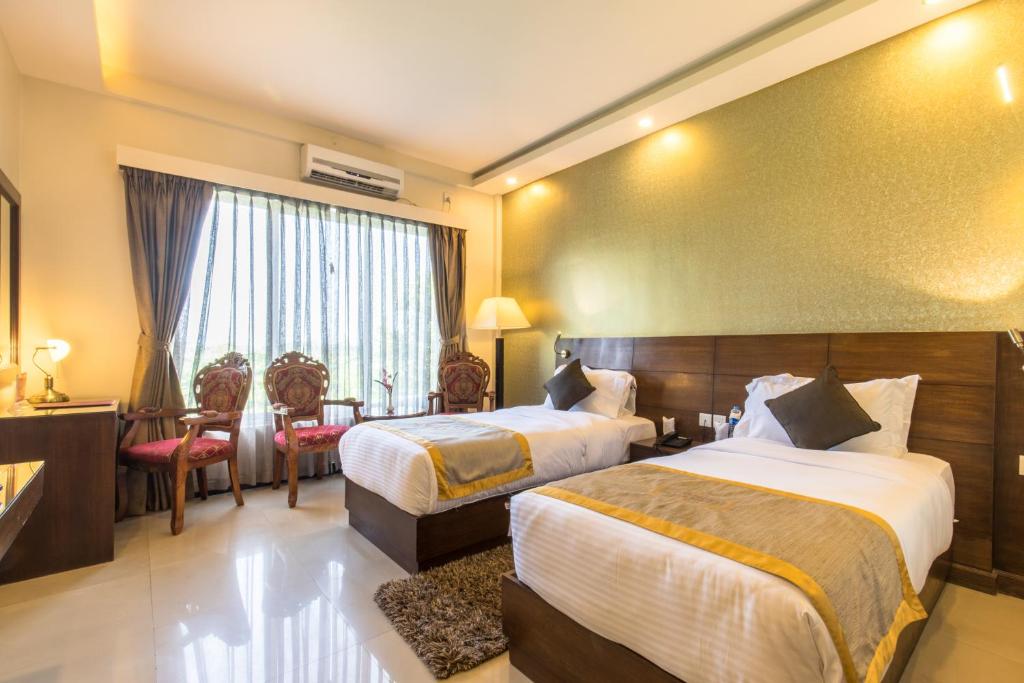 Rúm í herbergi á Hotel Ichchha