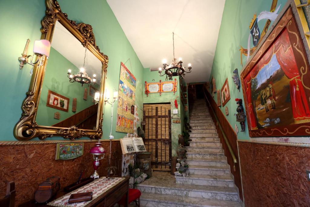 a staircase in a room with a mirror and some stairs at Sicilia In Miniatura "L'Atelier dell'Etna" in Zafferana Etnea