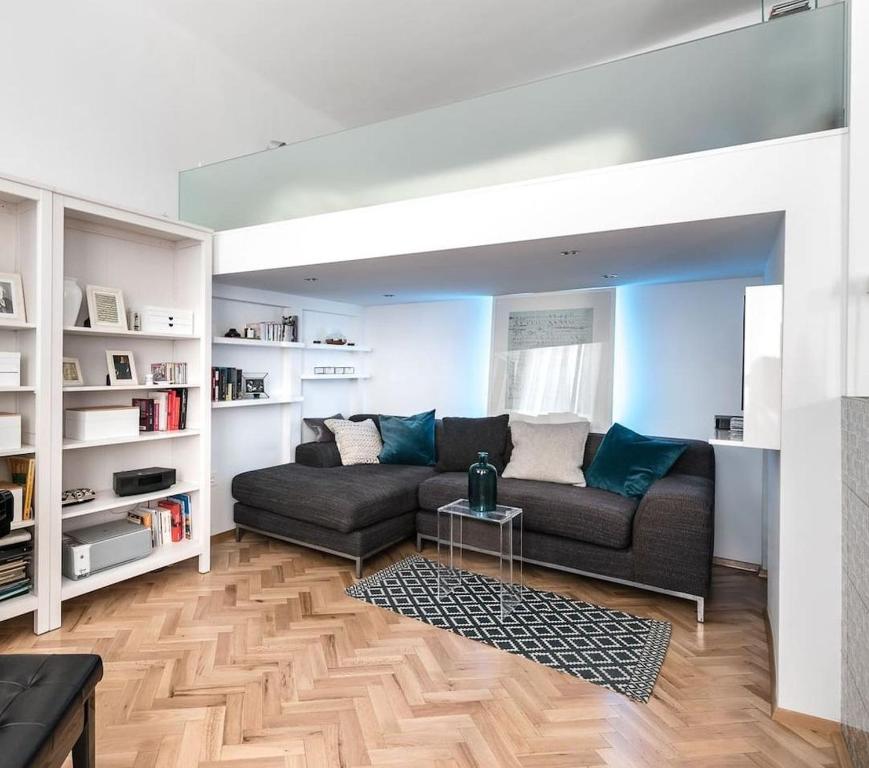 a living room with a couch and a table at Elegant Apartment in Budapest