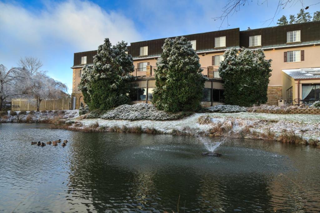 a pond in front of a building with ducks in it at Meadowbrook Inn in Blowing Rock
