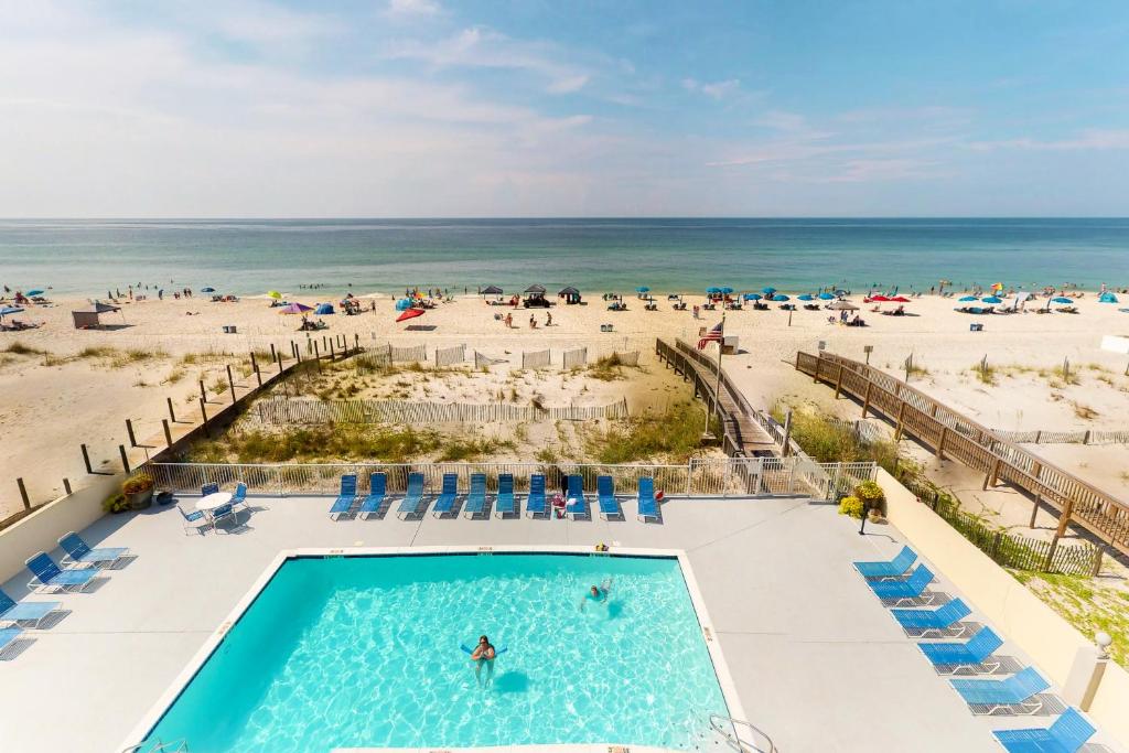 an overhead view of a pool and the beach at The Gulf Tower Condos in Gulf Shores