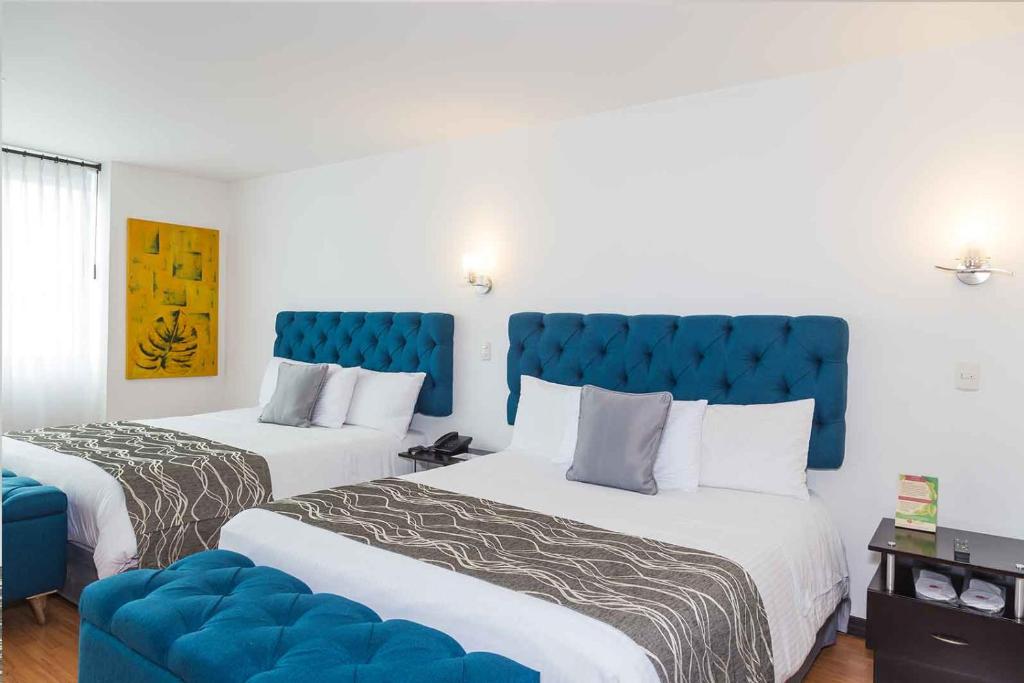 Posteľ alebo postele v izbe v ubytovaní Hotel Varuna