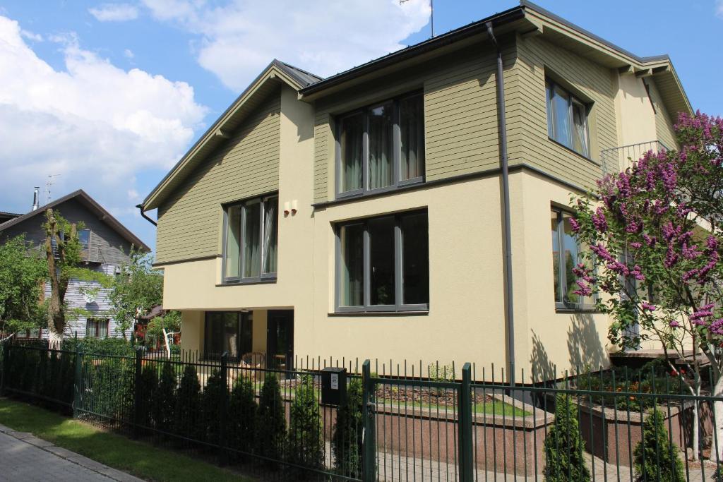 a house with a fence in front of it at Vila Nida in Palanga