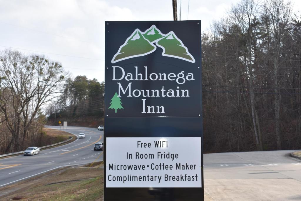 a sign for a mountain inn next to a road at Dahlonega Mountain Inn in Dahlonega