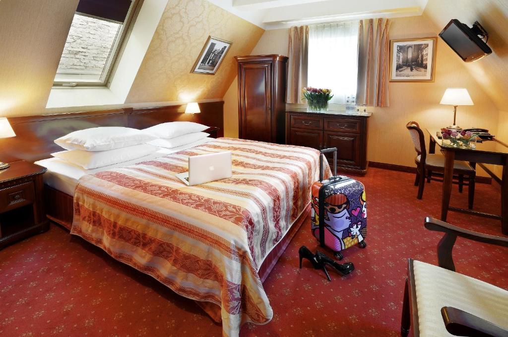 Postel nebo postele na pokoji v ubytování Hotel Wolne Miasto Old Town Gdańsk