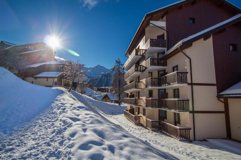 a snow covered street in front of a building at 23 Praz de l'Ours Vallandry - Les Arcs in Peisey-Nancroix