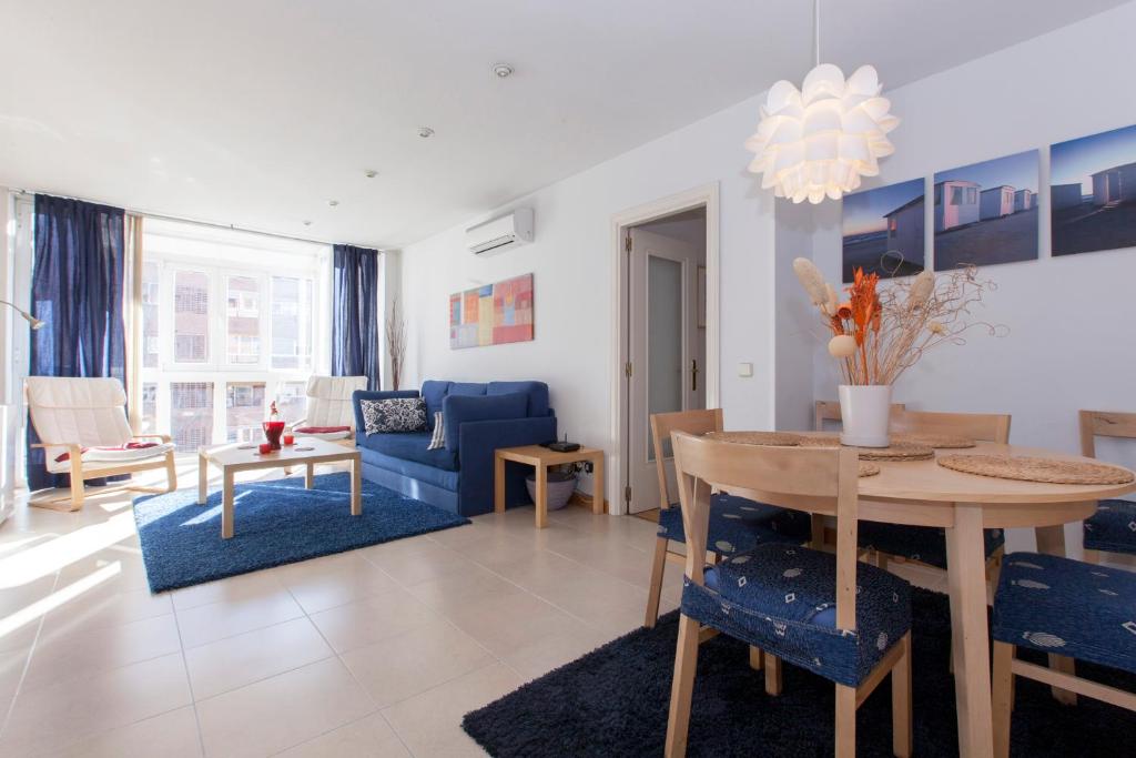 een woonkamer met een tafel en een blauwe bank bij Ribera in Madrid