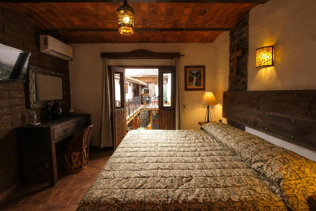 Postel nebo postele na pokoji v ubytování Hotel Mi Pueblito Tapalpa