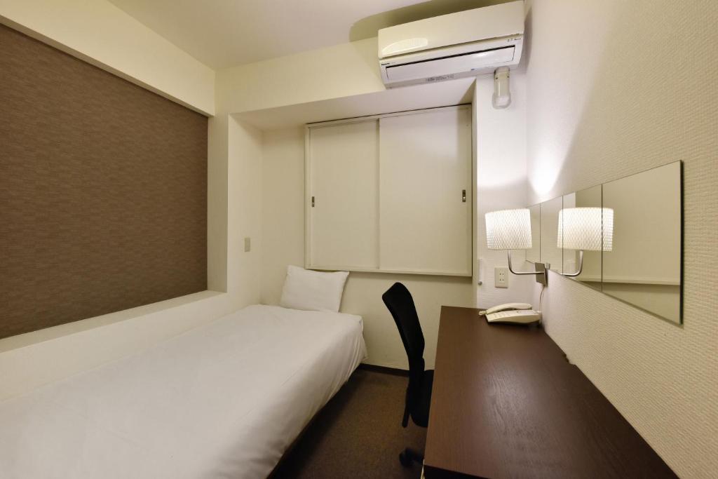 Postel nebo postele na pokoji v ubytování Hotel Kansai