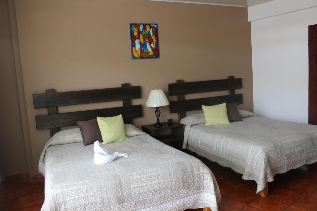 Postel nebo postele na pokoji v ubytování Hotel Arenal by Regina