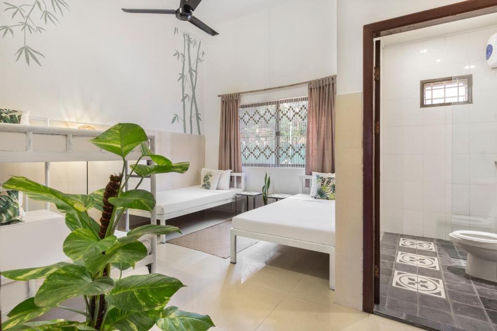 Postel nebo postele na pokoji v ubytování Babel Siem Reap Guesthouse