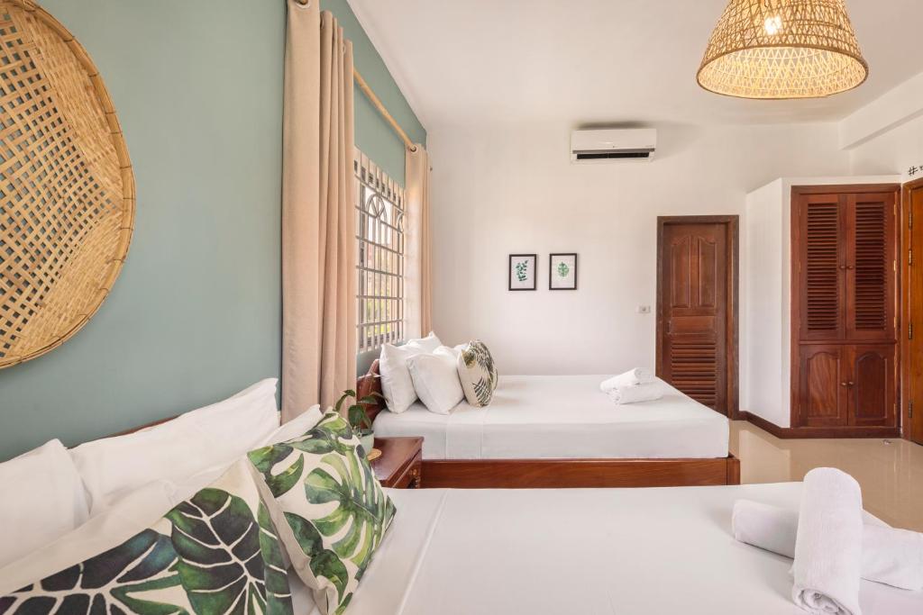 Postel nebo postele na pokoji v ubytování Babel Siem Reap Guesthouse