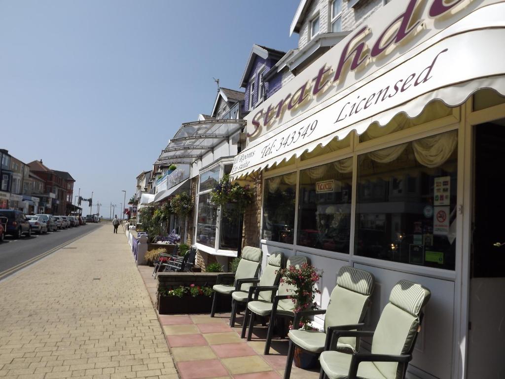 a row of chairs sitting outside of a restaurant at The Strathdon in Blackpool