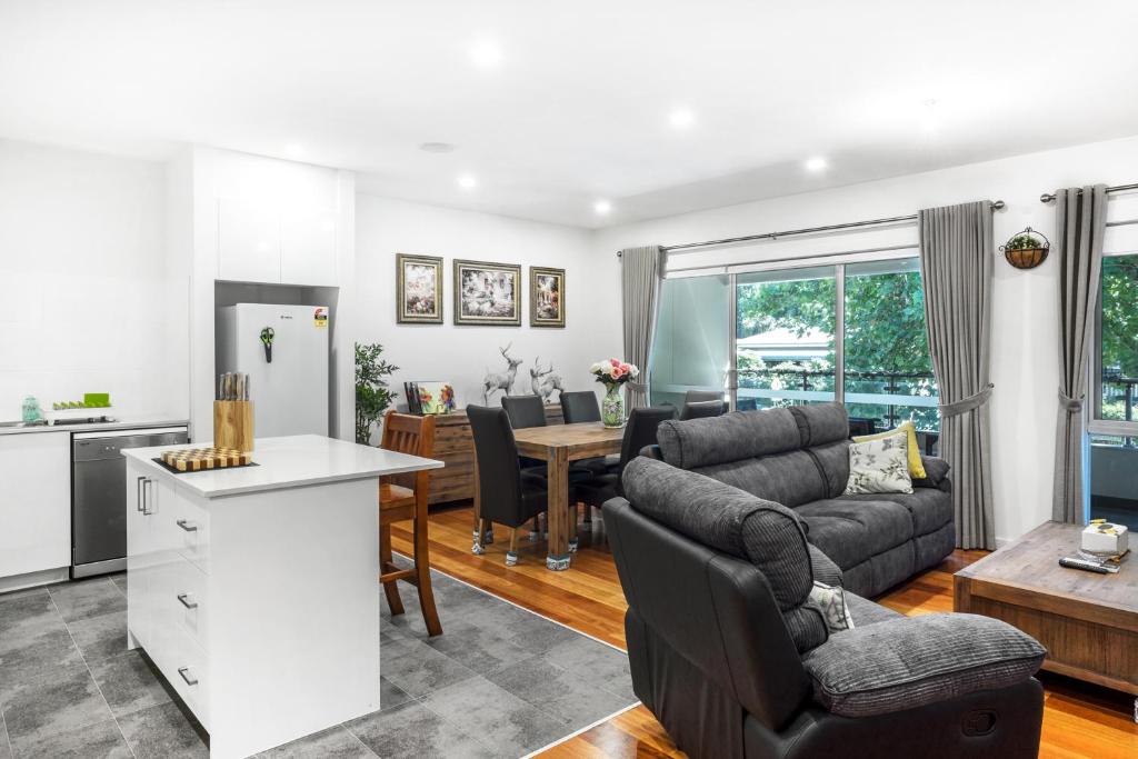 a kitchen and living room with a couch and a table at Olinda Village Apartment - A2 in Olinda