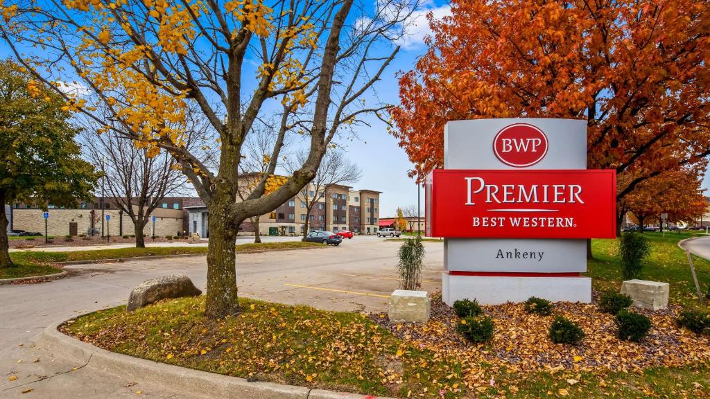 a sign for a premier best western on a street at Best Western Premier Ankeny Hotel in Ankeny