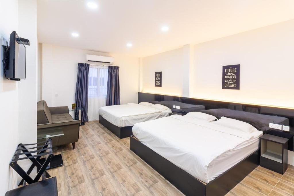 Postel nebo postele na pokoji v ubytování Tambun Warm Hotel